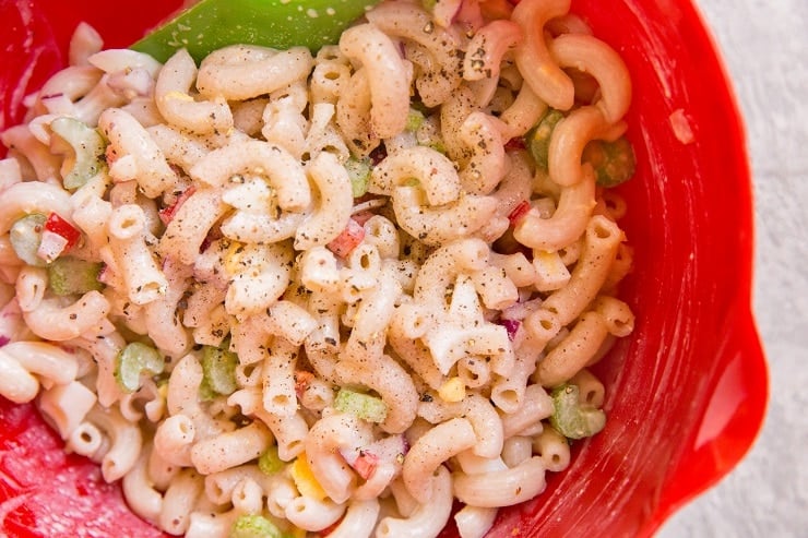 Stir ingredients for macaroni salad in a mixing bowl