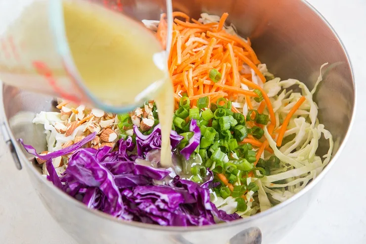 Pour the coleslaw dressing into the mixing bowl with the veggies
