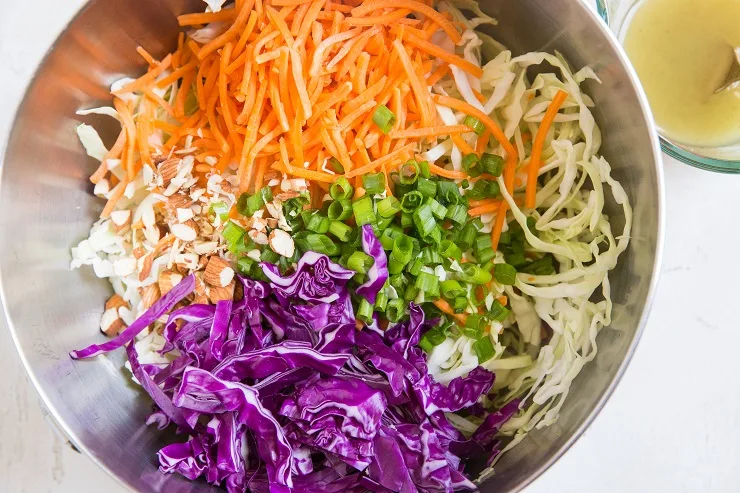 Add the vegetables for the coleslaw to a mixing bowl