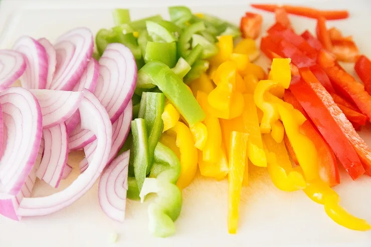 Chopped onions and peppers on a cutting board