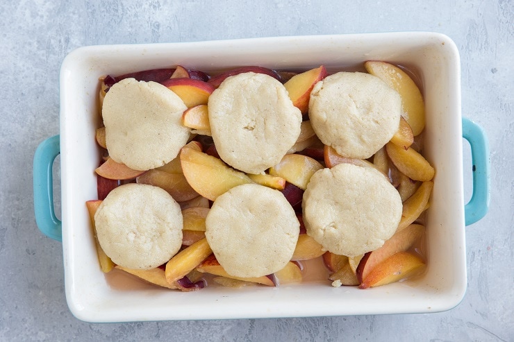 Form biscuits out of the almond flour topping and place on top of the peach filling