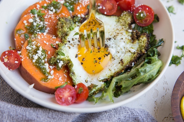 Pesto Eggs Breakfast Bowls with sweet potato, greens, cherry tomatoes and feta is a delicious and nourishing way to start the day!