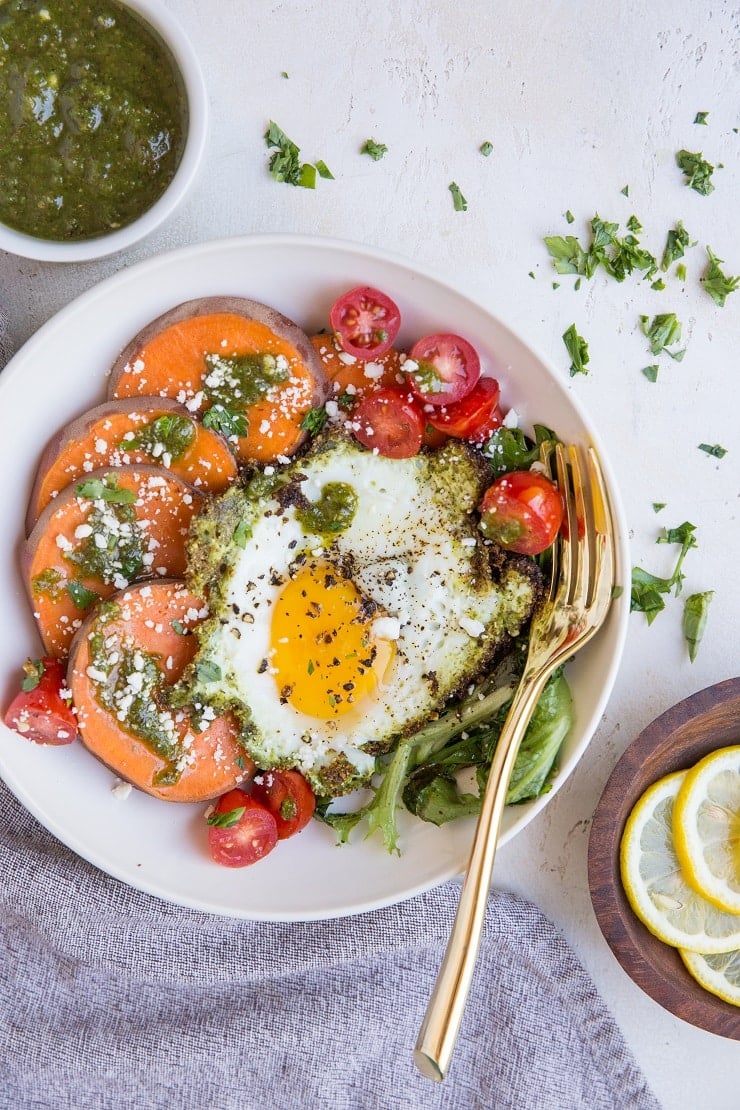 Pesto Eggs Breakfast Bowls with sweet potato, greens, cherry tomatoes and feta is a delicious and nourishing way to start the day!