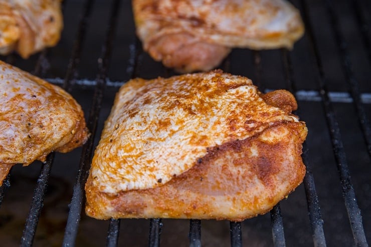 Marinated chicken thighs on a smoker
