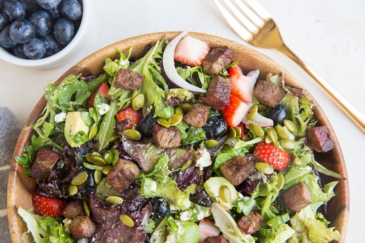 Easy Steak Salad with Berries, Avocado, Green Goddess Dressing, Feta, Green Onion, Pumpkin Seeds, and more! A marvelously refreshing summer salad recipe