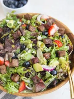 Easy Steak Salad with Berries, Avocado, Green Goddess Dressing, Feta, Green Onion, Pumpkin Seeds, and more! A marvelously refreshing summer salad recipe