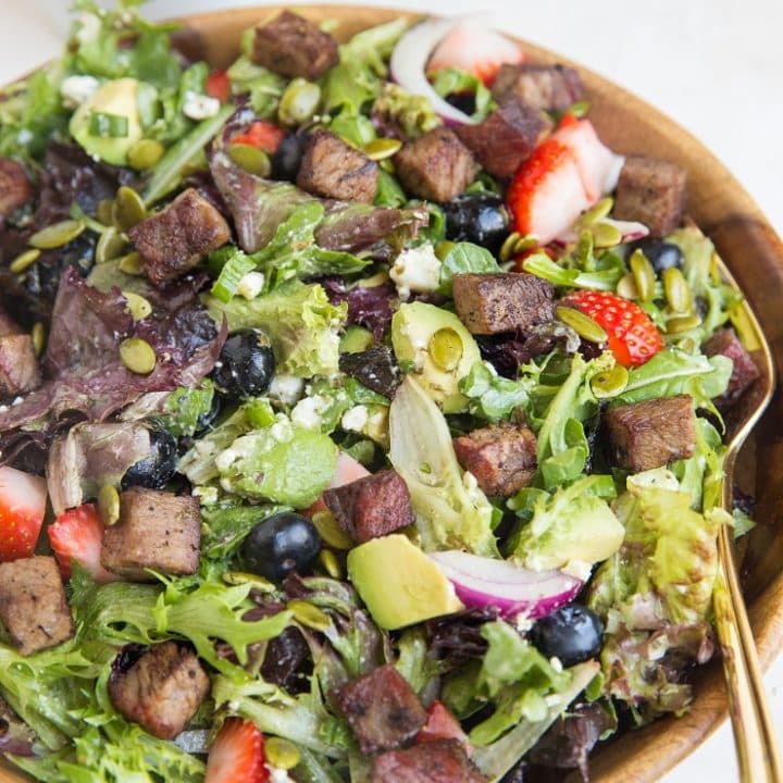 Easy Steak Salad with Berries, Avocado, Green Goddess Dressing, Feta, Green Onion, Pumpkin Seeds, and more! A marvelously refreshing summer salad recipe