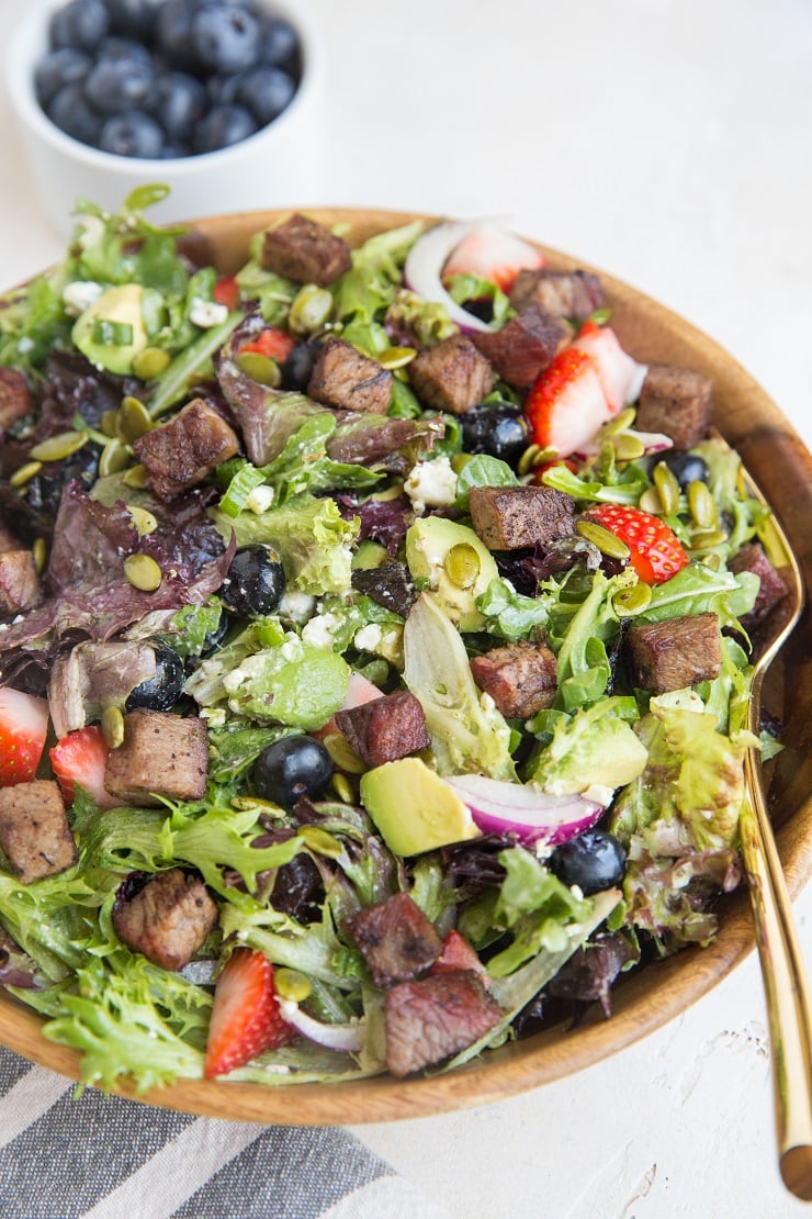 Easy Steak Salad with Berries, Avocado, Green Goddess Dressing, Feta, Green Onion, Pumpkin Seeds, and more! A marvelously refreshing summer salad recipe