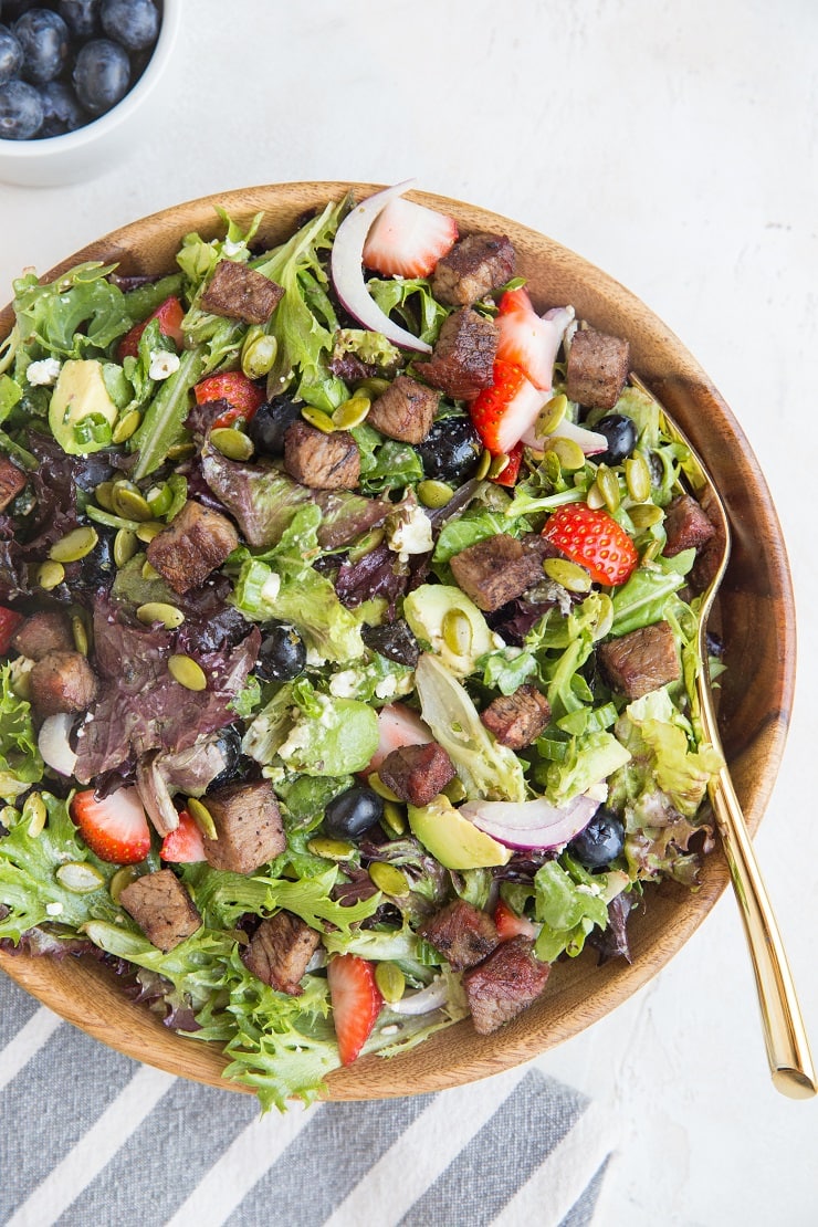 Steak Salad with Berries, Avocado, Feta, Red Onion, Pumpkin Seeds, and Goddess Dressing - a delicious summer dinner recipe!