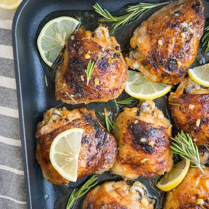 Easy Baked Garlic Lemon Rosemary Chicken - fall-off-the-bone tender delicious chicken thighs with perfect crispy skin - a simple yet magnificently flavorful dinner