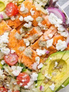 Greek Salmon Salad with cucumbers, avocado, red onion, feta, cherry tomatoes, and an herby dressing. This simple, nourishing recipe is loaded with fresh flavor and is low-carb keto friendly