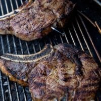 Grilled ribeye steaks on a grill