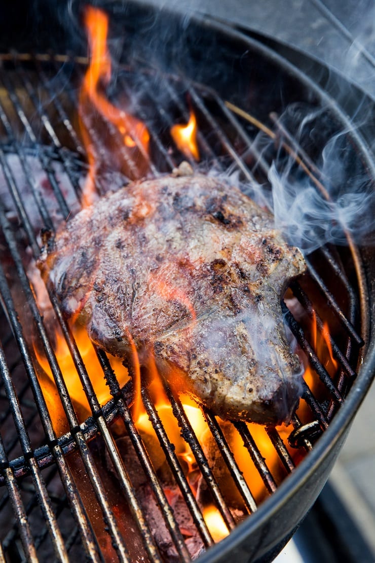 Grilling steak on a charcoal grill