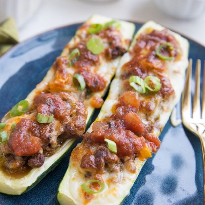 Taco Stuffed Zucchini with ground beef, onion, bell peppers, and more. Cheesy, low-carb, delicious!