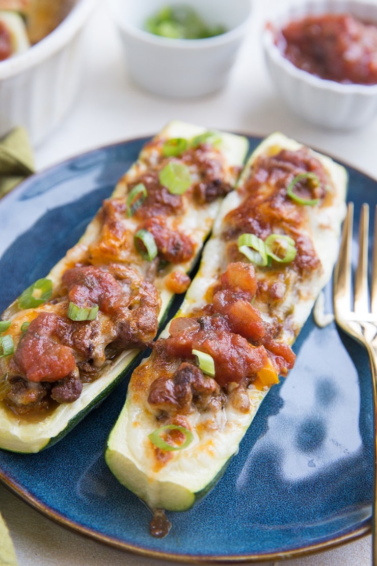 Taco Stuffed Zucchini with ground beef, onion, bell peppers, and more. Cheesy, low-carb, delicious!