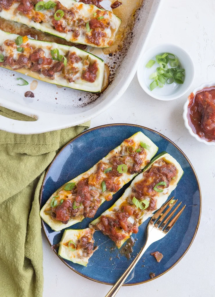 Easy Taco Stuffed Zucchini with ground beef, onion, peppers, cheese, and more. A quick healthy low-carb keto dinner recipe