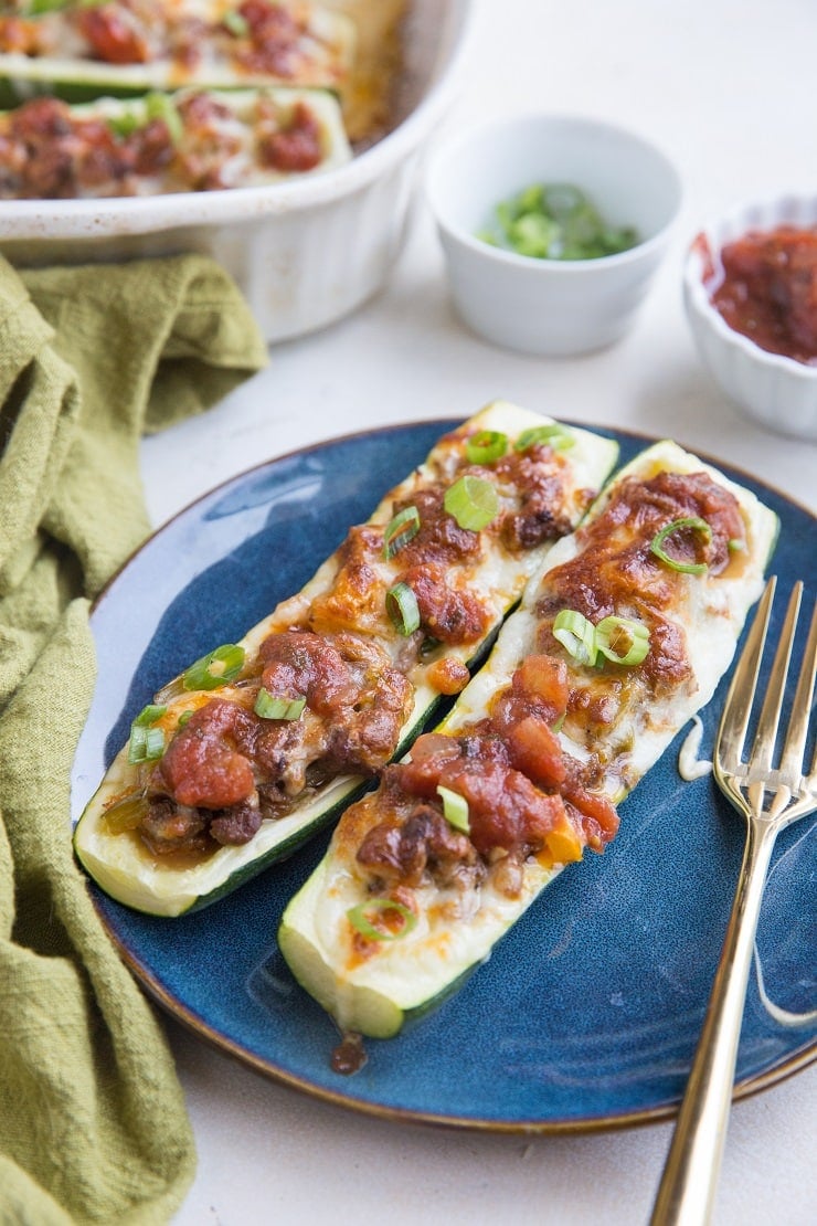 Taco Stuffed Zucchini Boats with ground beef and all the delicious taco seasonings. Easy, quick, low-carb, delicious!