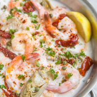 Creamy Tuscan Shrimp Recipe with sun-dried tomatoes, artichoke hearts, and more! Dairy-free, paleo, whole30, keto and delicious!