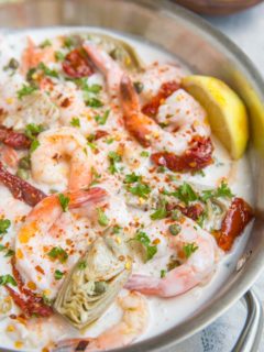 Creamy Tuscan Shrimp Recipe with sun-dried tomatoes, artichoke hearts, and more! Dairy-free, paleo, whole30, keto and delicious!