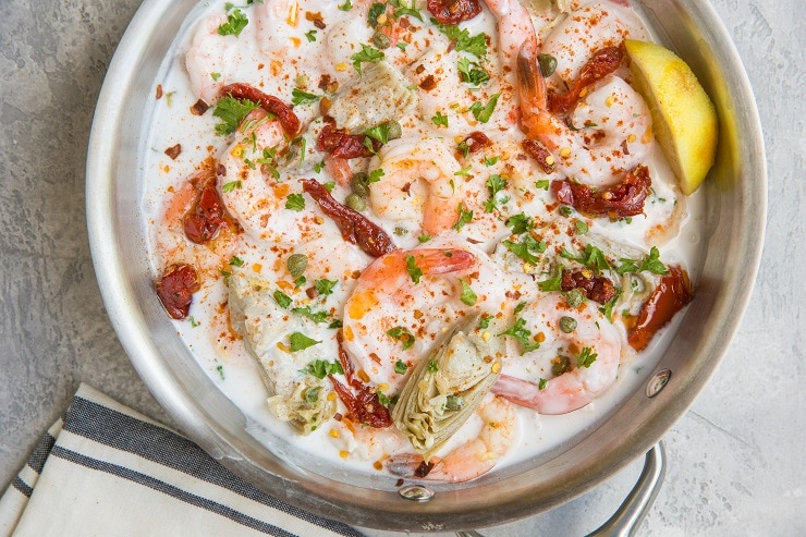 Easy Dairy-Free Creamy Tuscan Shrimp Recipe with artichoke hearts and sun-dried tomatoes. An easy main dish or side dish.