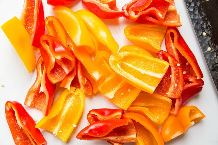Slice the tops off the peppers and cut lengthwise