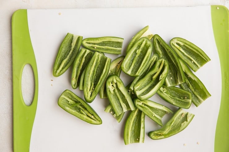 Slice the tops off of the jalapenos and cut in half lengthwise. Remove the seeds