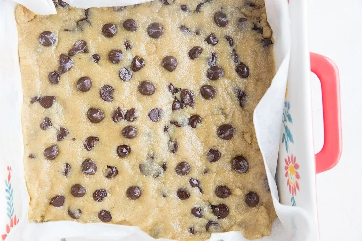 Spread the cookie dough bar into an even layer in a baking pan
