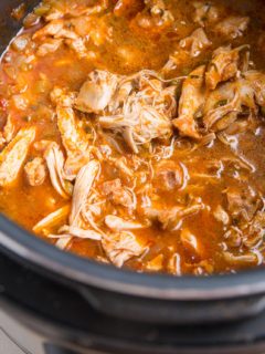 Instant Pot Mexican shredded chicken in a pressure cooker, ready to serve.