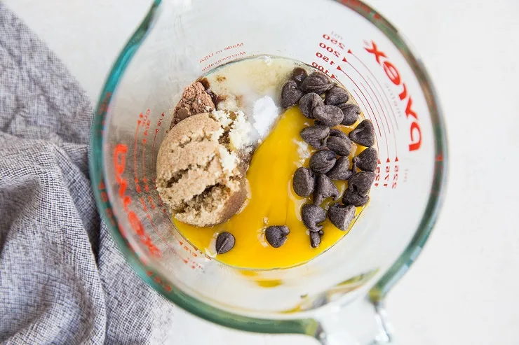 Ingredients for chocolate mug cake in a measuring cup