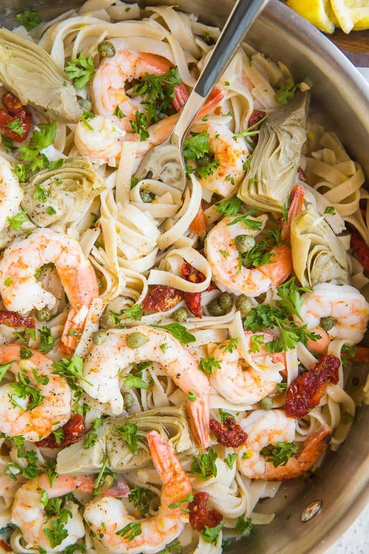 Dairy-Free Gluten-Free Mediterranean Shrimp Pasta with capers, artichoke hearts, sun-dried tomatoes and a creamy lemon garlic sauce is a light and healthy pasta recipe!