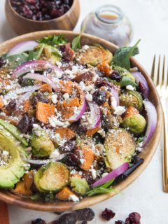 Roasted Sweet Potato and Brussel Sprout Salad with Cinnamon Balsamic Dressing is a nutritious fall-inspired salad