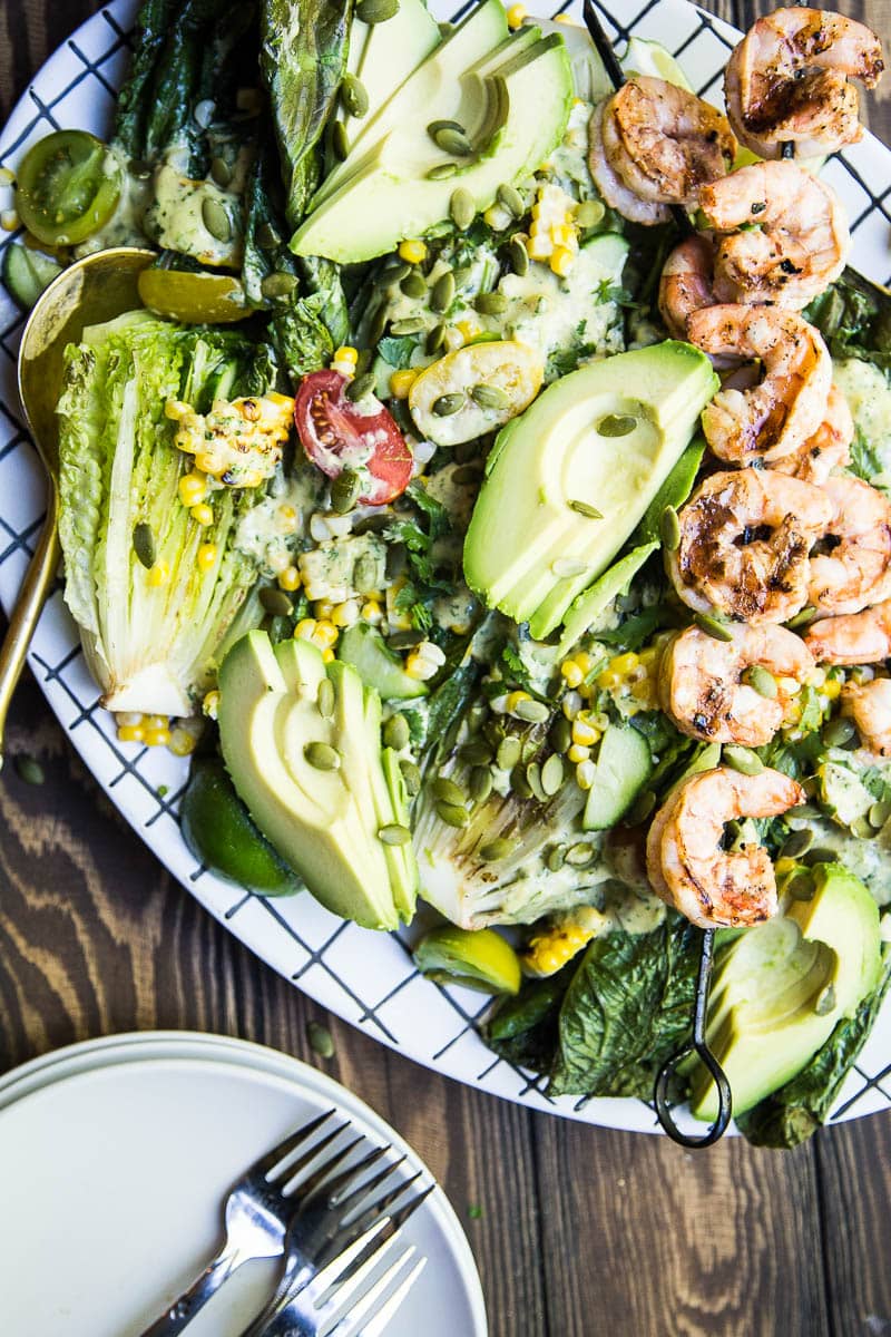 Santa Fe Grilled Caesar Salad with Shrimp - A completely delicious, fresh take on classic Caesar salad, this Santa Fe Grilled Caesar features corn, shrimp, avocado, and the most amazing dressing! Finally, a salad that feels filling!