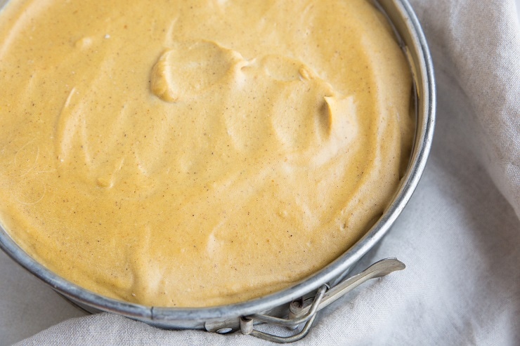 Spread the pumpkin cheesecake filling into an even layer over the crust