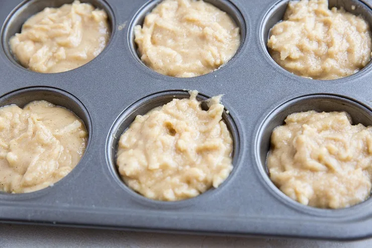 Apple muffin batter in a muffin tray