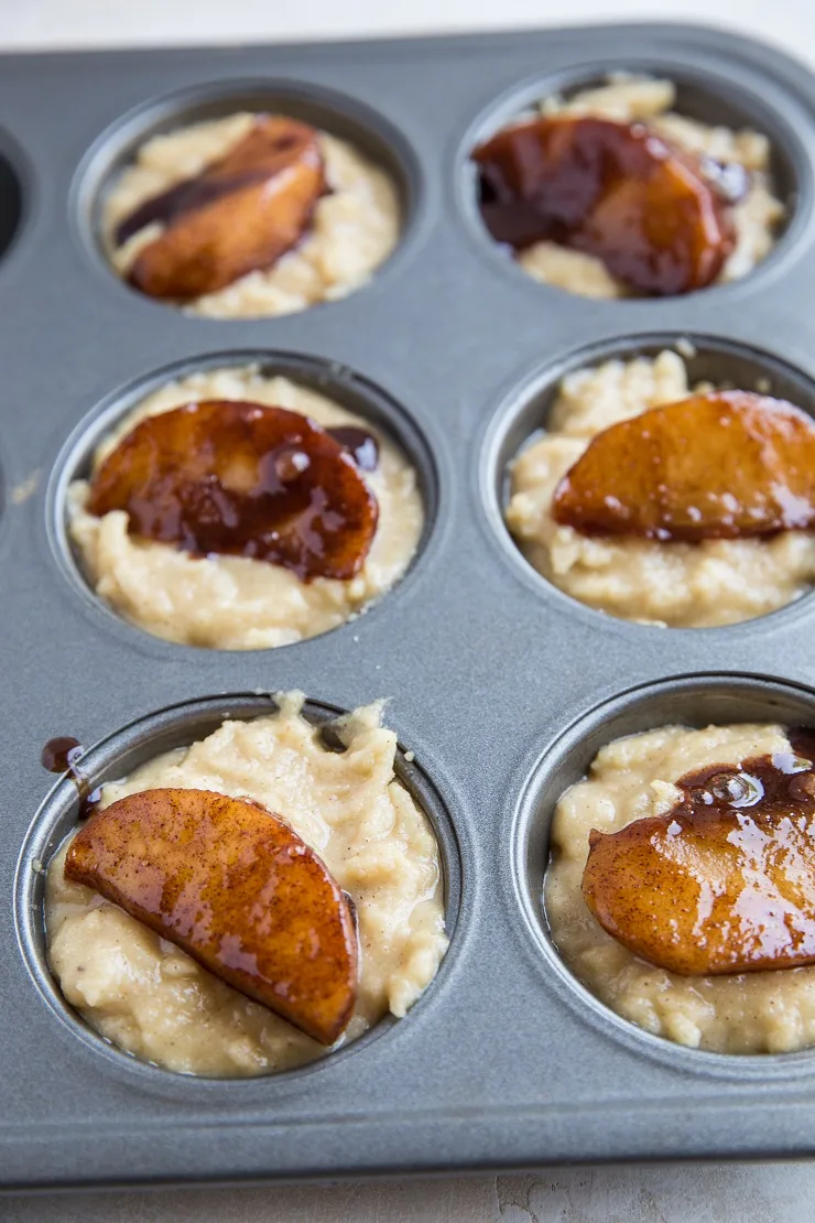 Add a caramelized apple on top of the muffin batter