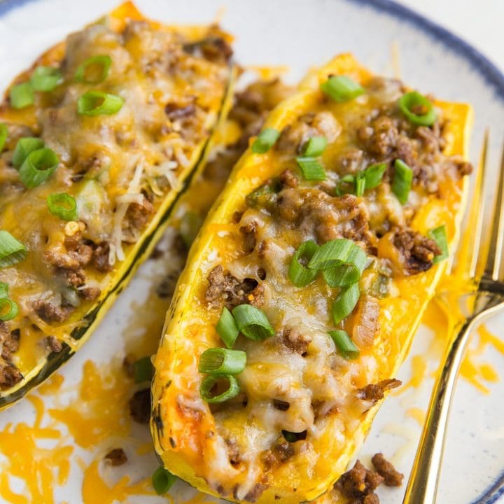 Taco Stuffed Delicata Squash with spiced ground beef, onion, and cheese. This simple, clean meal is nourishing, easy to prepare, and perfect for fall or winter!