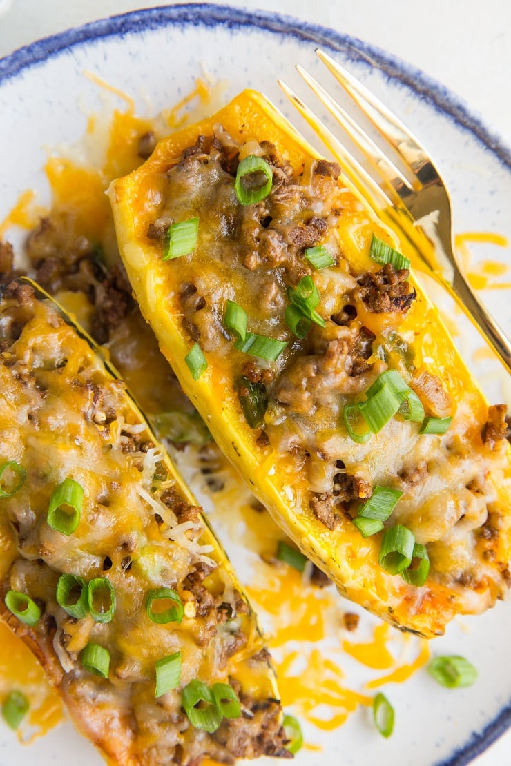 Taco Stuffed Delicata Squash with ground beef and cheese. An easy dinner recipe that is grain-free, gluten-free, easy to prepare and so satisfying!