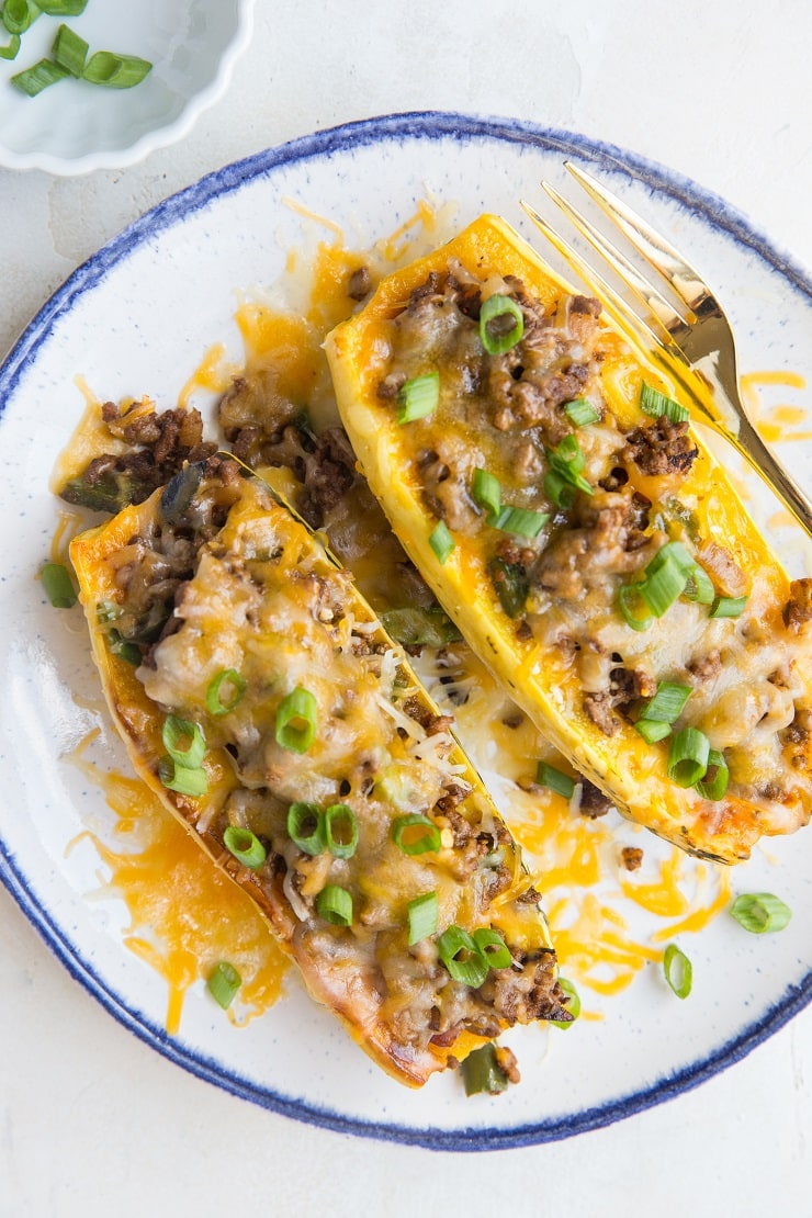 Taco Stuffed Delicata Squash with ground beef and cheese. An easy dinner recipe that is grain-free, gluten-free, easy to prepare and completely delicious!
