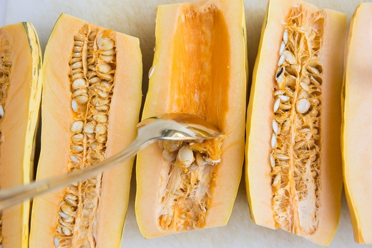 Cut the delicata squash in half and scoop out the insides