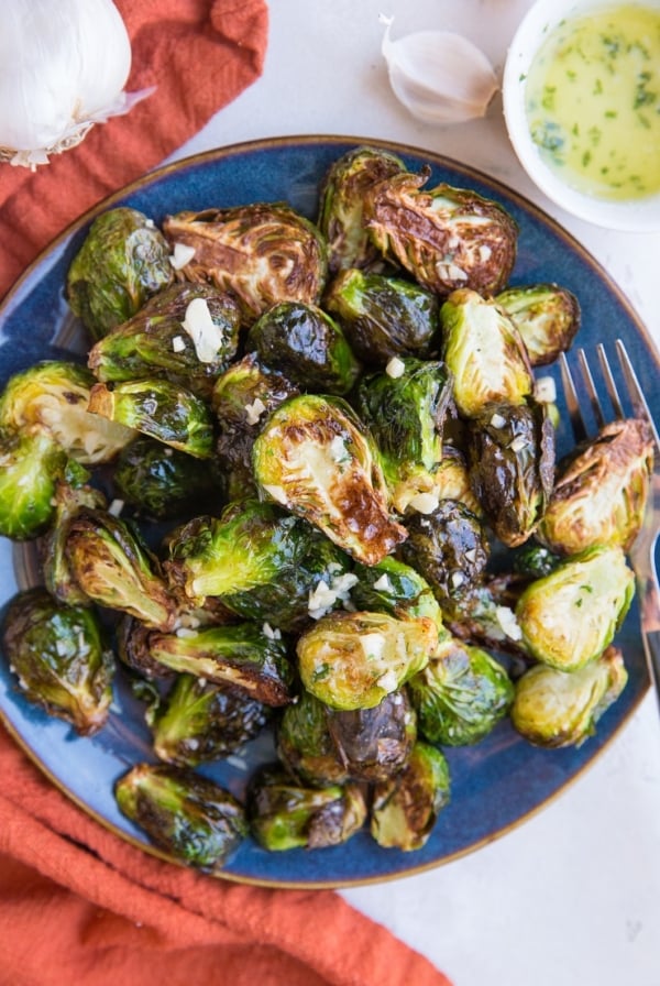 Air Fryer Garlic Butter Brussel Sprouts are easy to toss together any night of the week. The best golden-brown crispy, perfectly cooked brussels with tons of flavor!