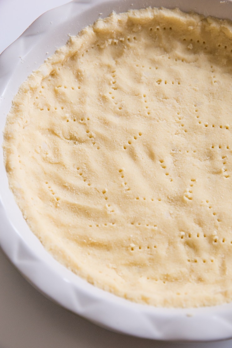 Press dough into a 9-inch pie dish and poke holes into it with a fork