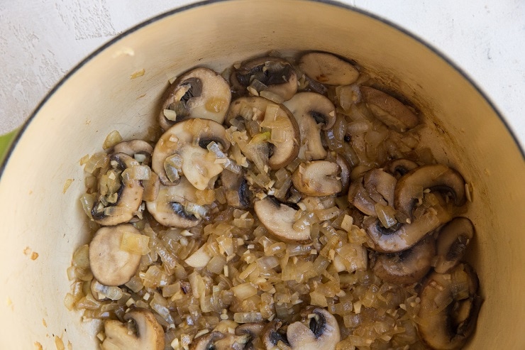 Saute the onion and mushrooms in a pot