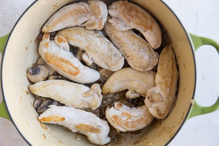 Transfer the chicken back into the pot with the sautéed onion and mushrooms