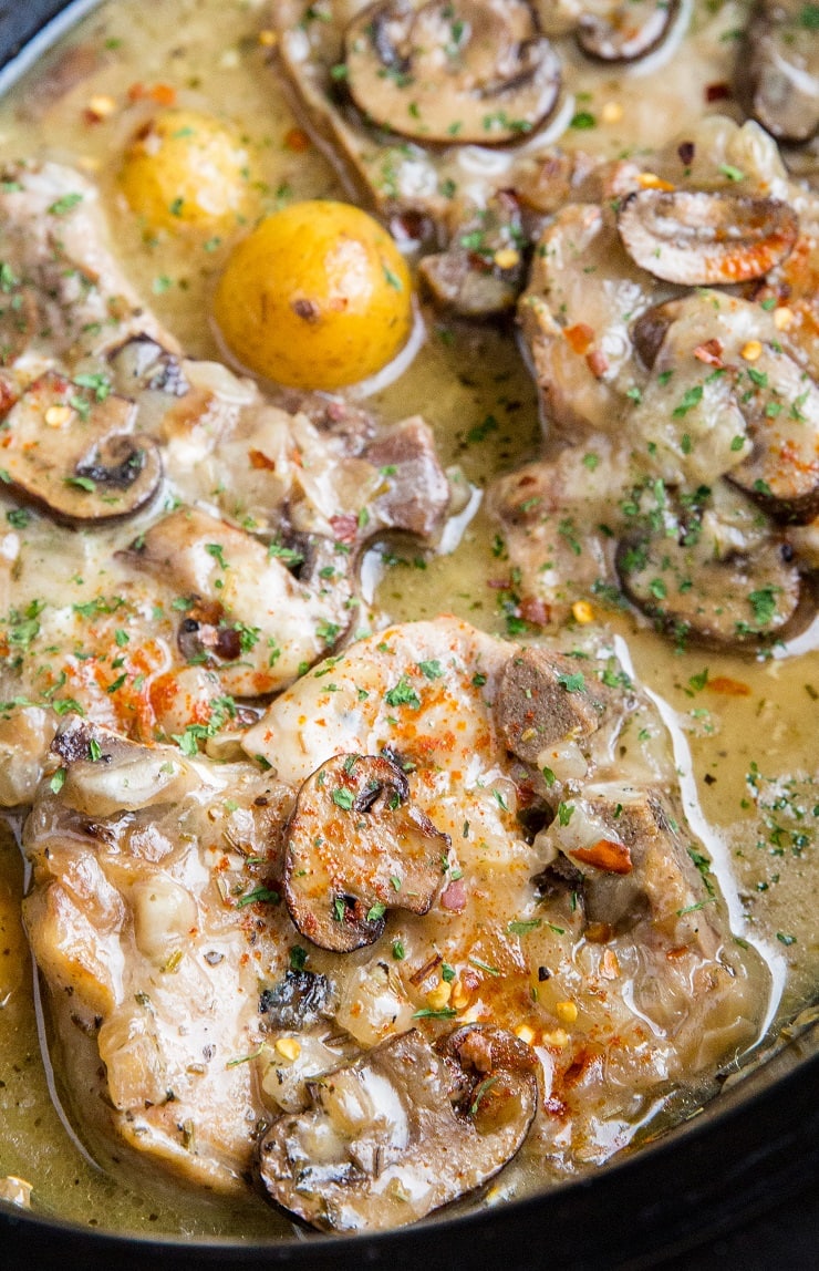 Slow Cooker Pork Chops with garlic cream sauce, potatoes and mushrooms. A healthy, filling comfort food recipe.