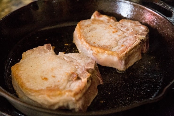 Sear the pork chops until golden-brown