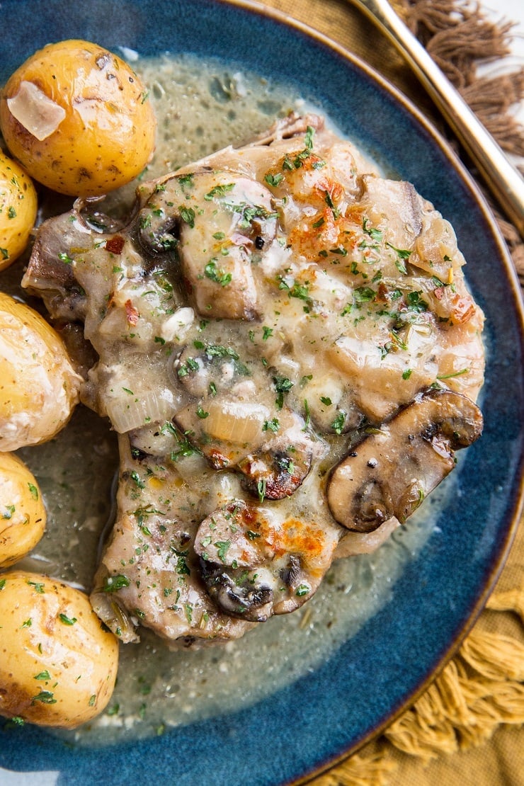 Slow Cooker Pork Chops with creamy garlic sauce, potatoes, and mushrooms