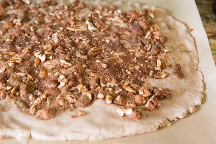 Spread the coconut oil over the dough and sprinkle on the filling mixture