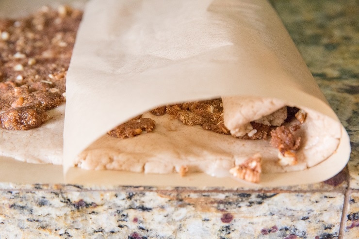 Use the parchment paper to help roll the dough into a log shape
