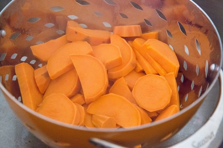 Boil the sweet potatoes until tender, then drain them into a colander.