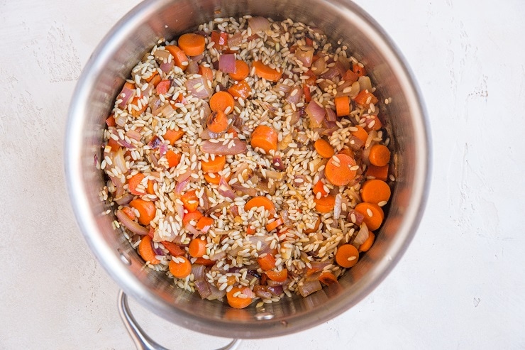 Sauté the onion, carrots, garlic and rice